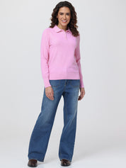 Woman wearing a pink sweater and blue jeans on a white background