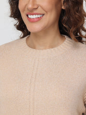 Close-up of a person wearing a beige sweater with a neutral background