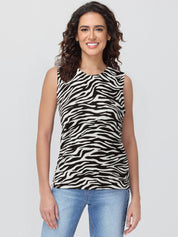 Woman wearing a zebra print sleeveless top against a plain background