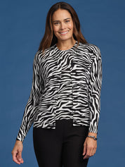 Woman wearing a zebra print cardigan against a blue background