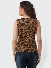 Woman wearing a sleeveless top with zebra pattern on a white background