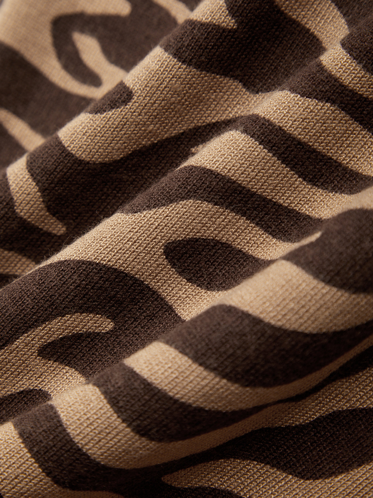 Close-up of brown and beige fabric with wavy pattern