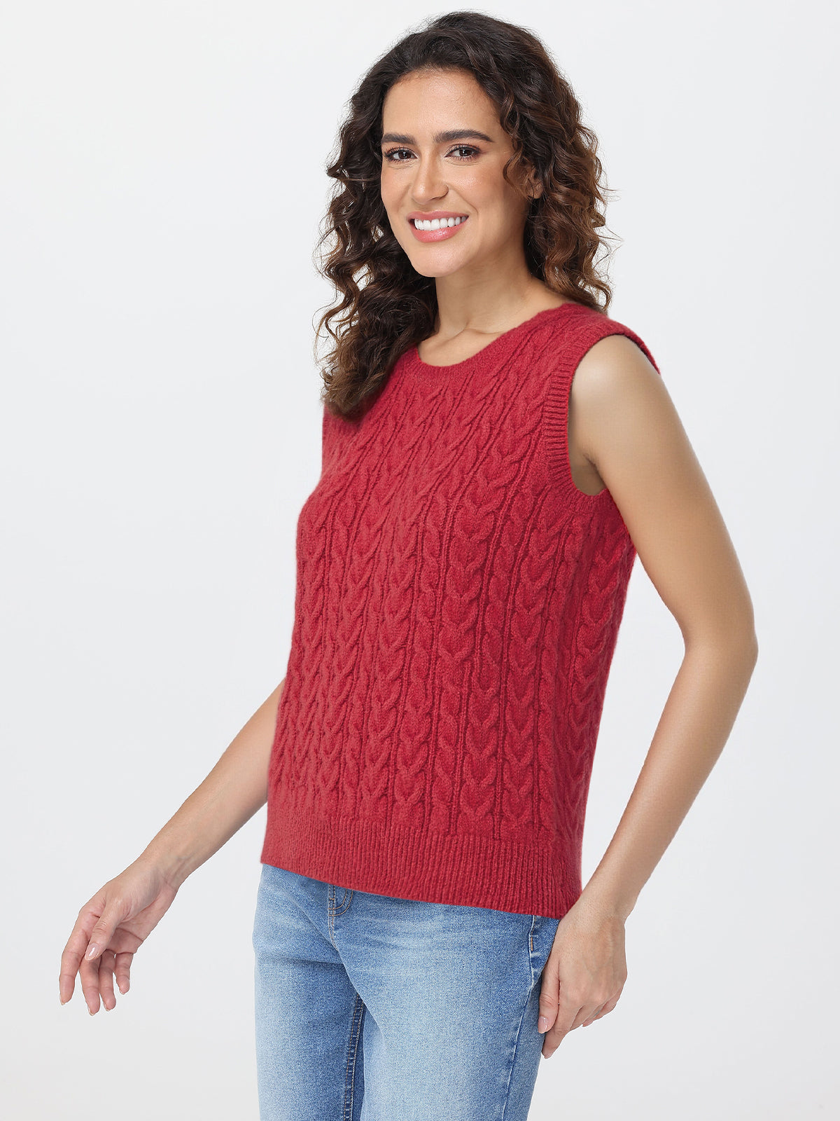 Woman wearing a red sleeveless knitted top with a white background
