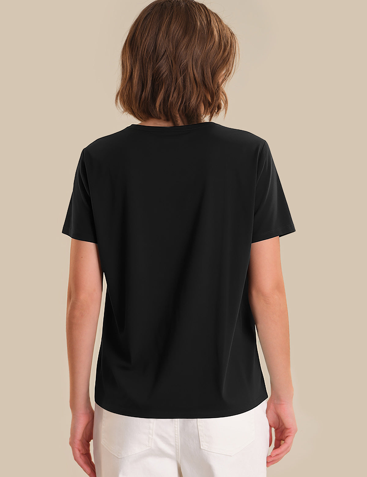 Person wearing a black t-shirt on a beige background