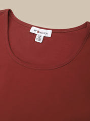 Close-up of a rust red scoop-neck top showing the inner neck label which reads '89TH MADSON'.