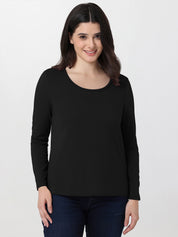 Woman wearing a black long-sleeve top on a white background