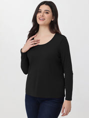 Woman wearing a black long-sleeve top on a white background