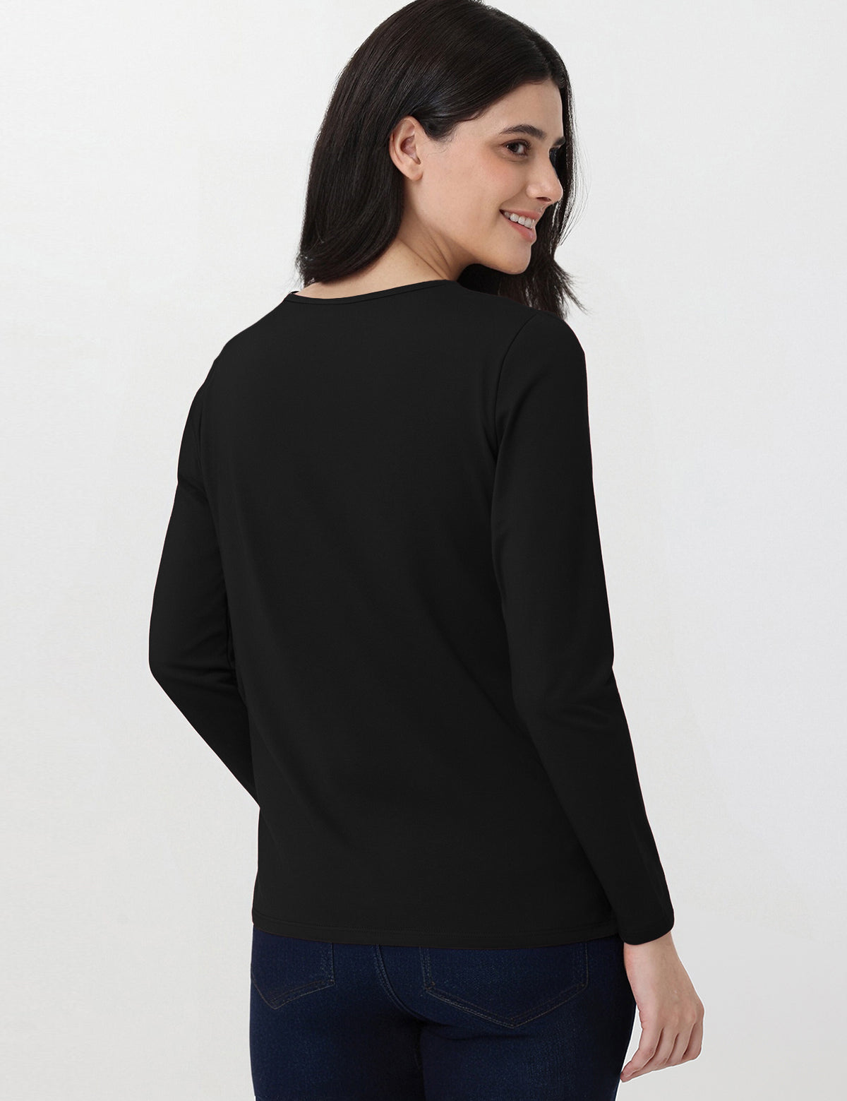 Woman wearing a black long-sleeve top on a white background