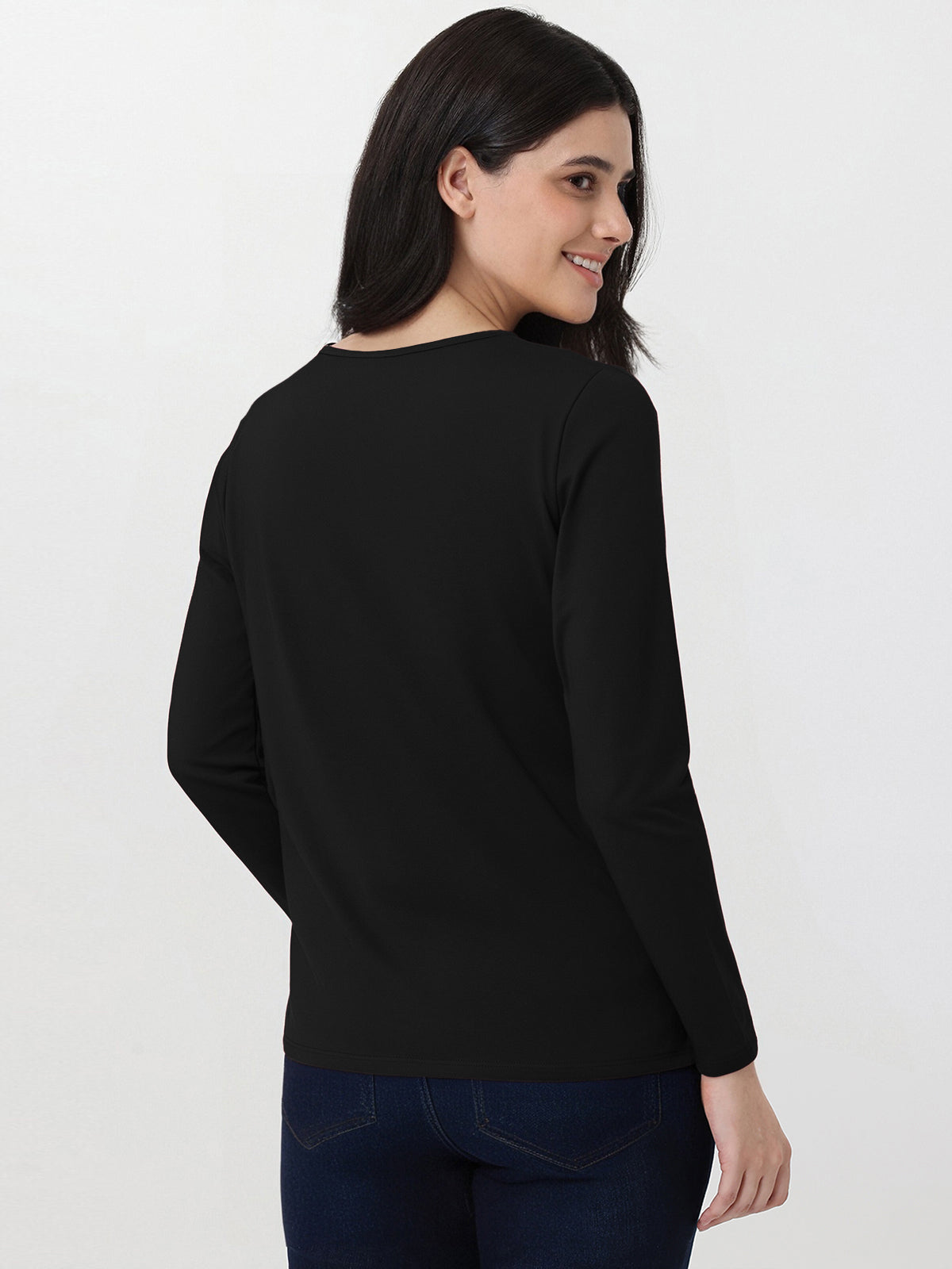 Woman wearing a black long-sleeve top on a white background