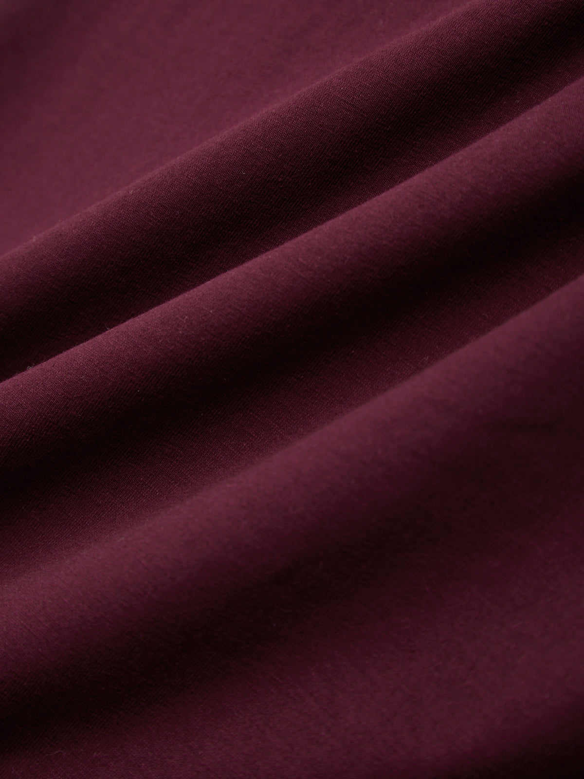 Close-up of burgundy fabric with folds