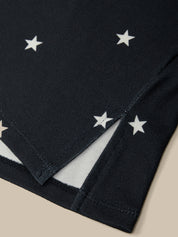 Black fabric with white star patterns on a beige background