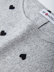 Gray sweater with black heart patterns and a visible brand label.