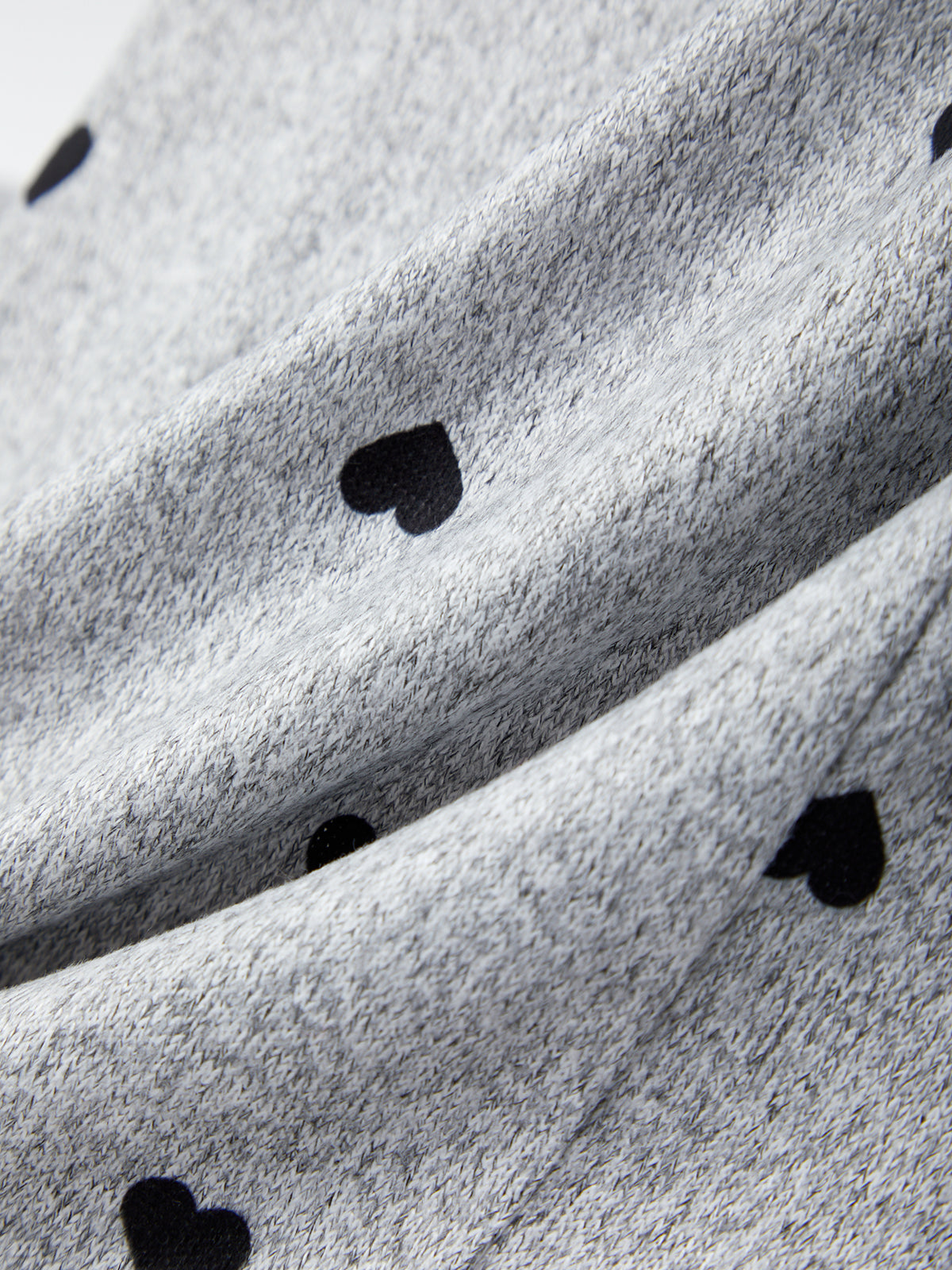 Close-up of gray fabric with black heart shapes