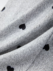 Close-up of gray fabric with black heart shapes