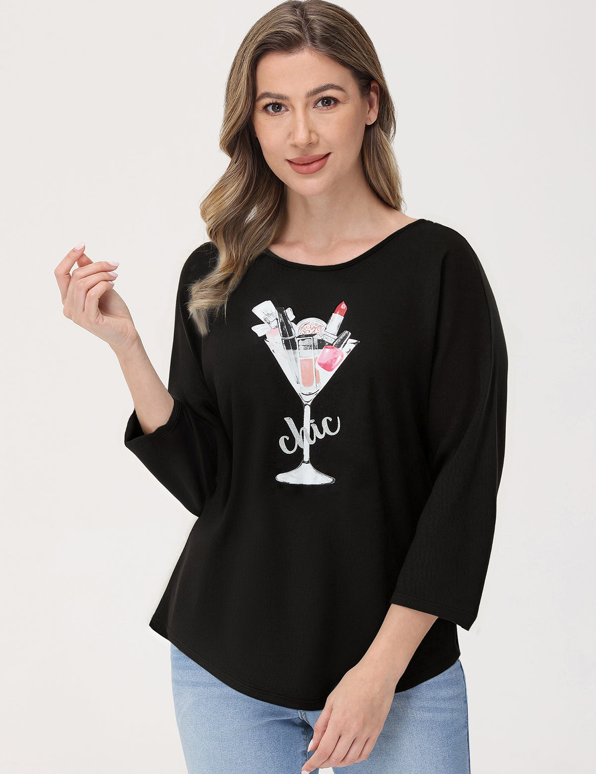 Woman wearing a black oversized shirt with a graphic design on a white background