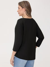 Woman wearing a black top and blue jeans on a white background