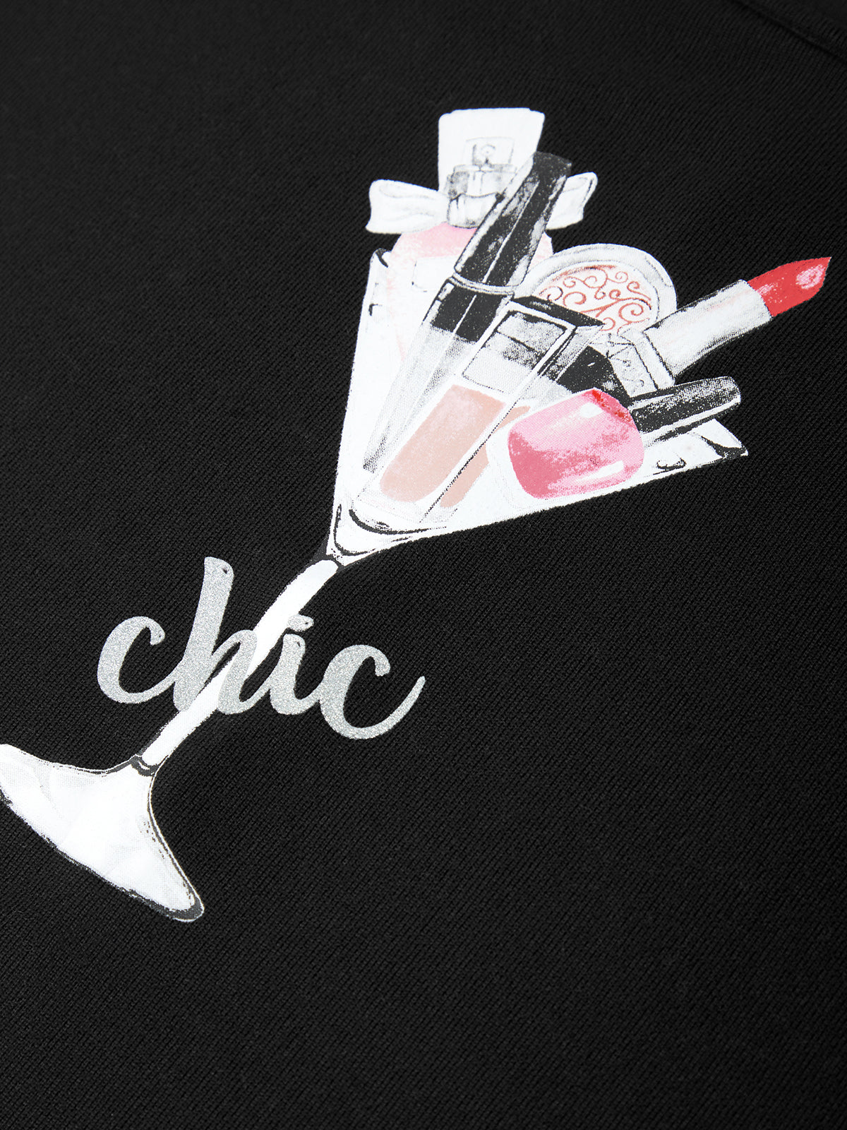 Black shirt with a design of a martini glass filled with makeup items and the word 'chic'.