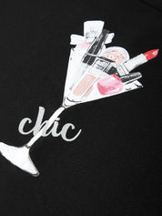 Black shirt with a design of a martini glass filled with makeup items and the word 'chic'.