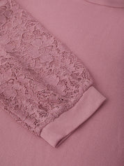 Pink garment with lace detailing on a matching fabric background