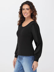 Woman wearing a black blouse and blue jeans on a white background