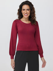 Woman wearing a red blouse with puffed sleeves on a white background