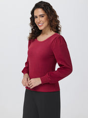 Woman wearing a red blouse with long sleeves on a white background