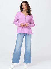 Woman wearing a pink blouse and blue jeans on a white background