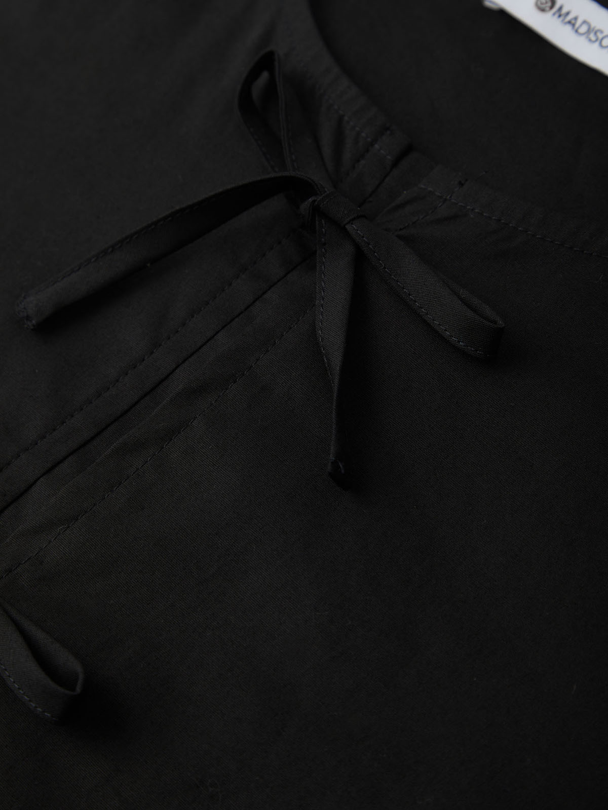 Black garment with a bow detail and 'MADISON' label.