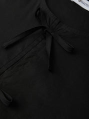 Black garment with a bow detail and 'MADISON' label.