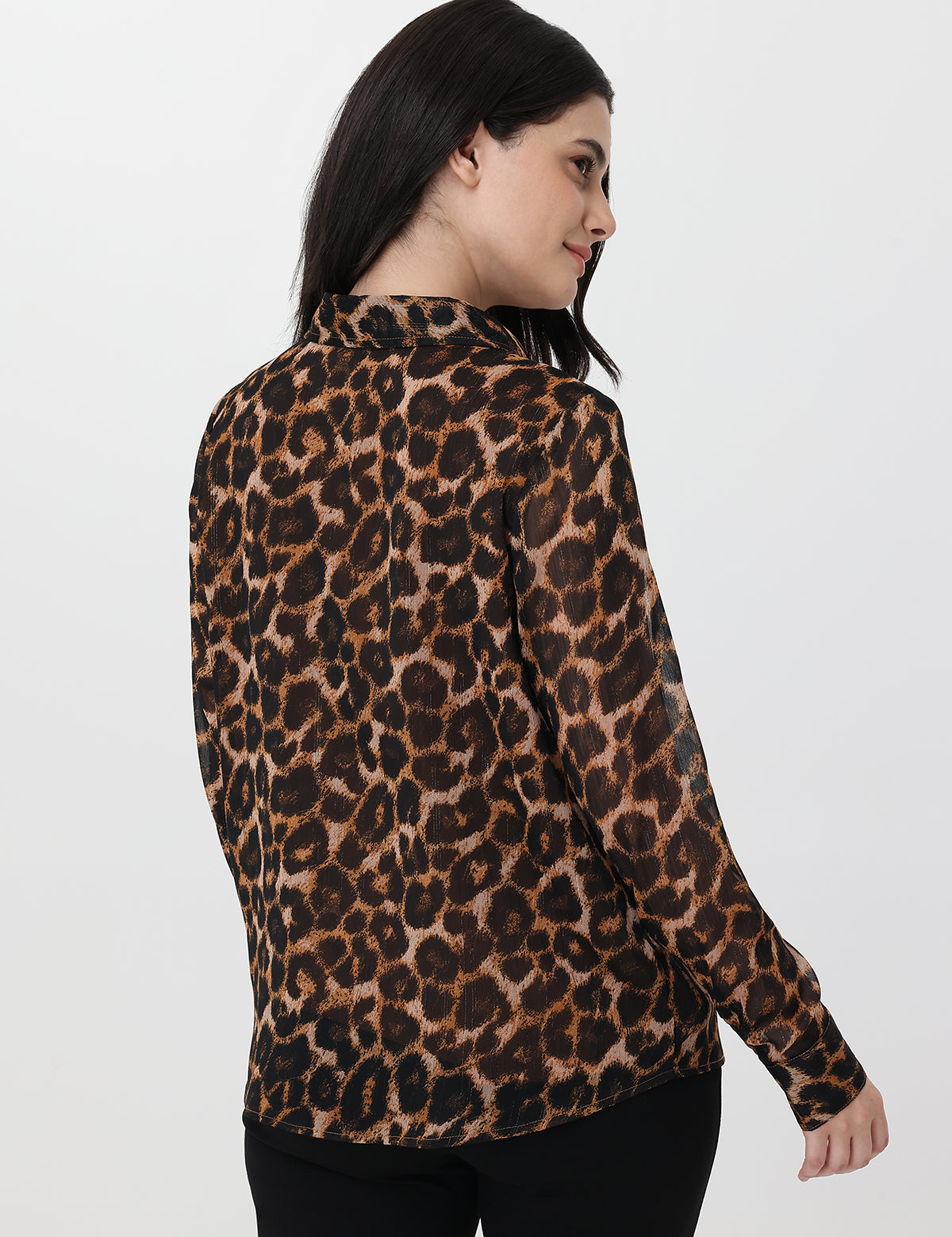 Woman wearing a leopard print blouse on a white background