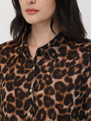Close-up of a person wearing a leopard print shirt with a neutral background