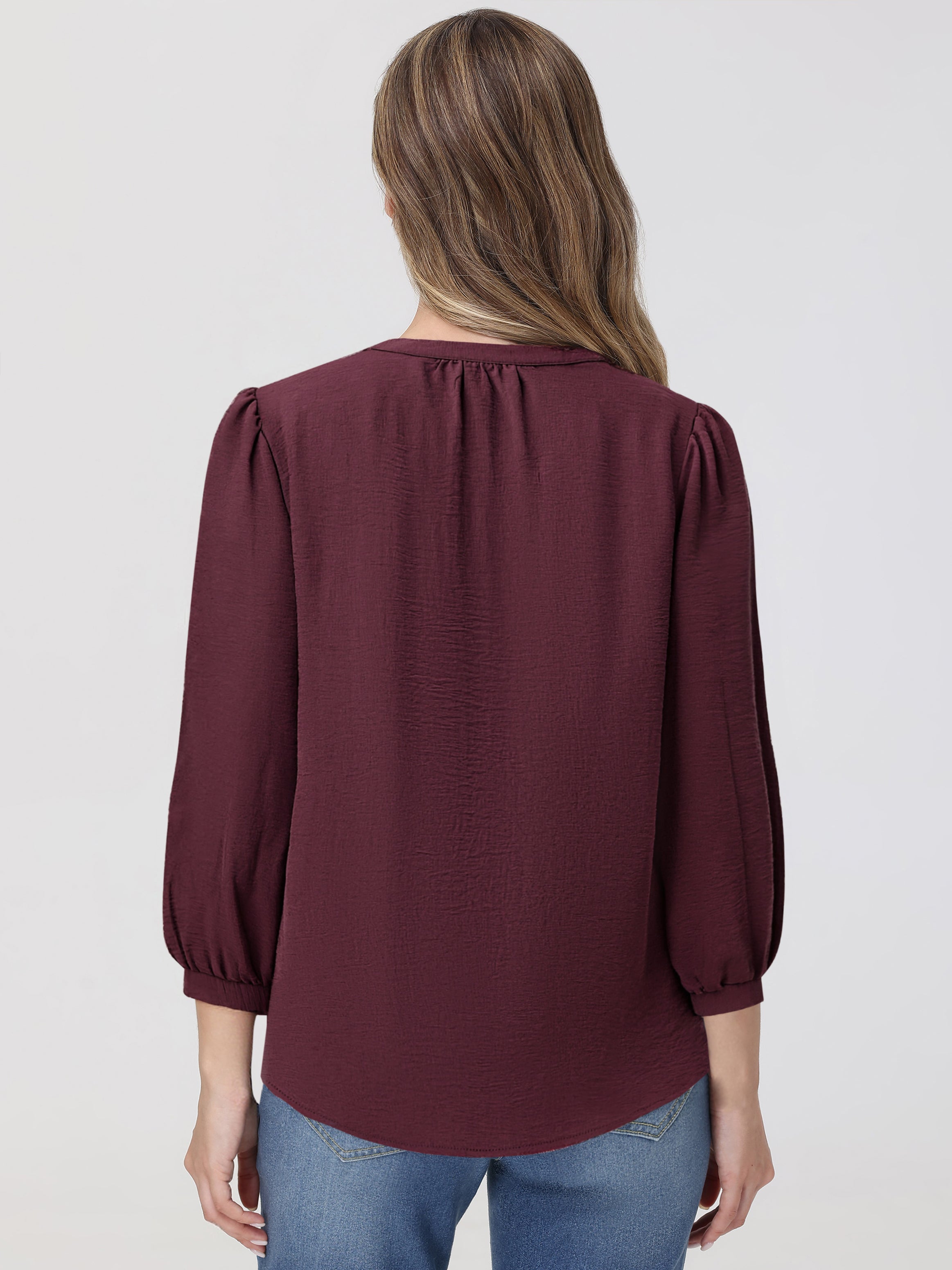 Maroon blouse worn by a person on a plain background