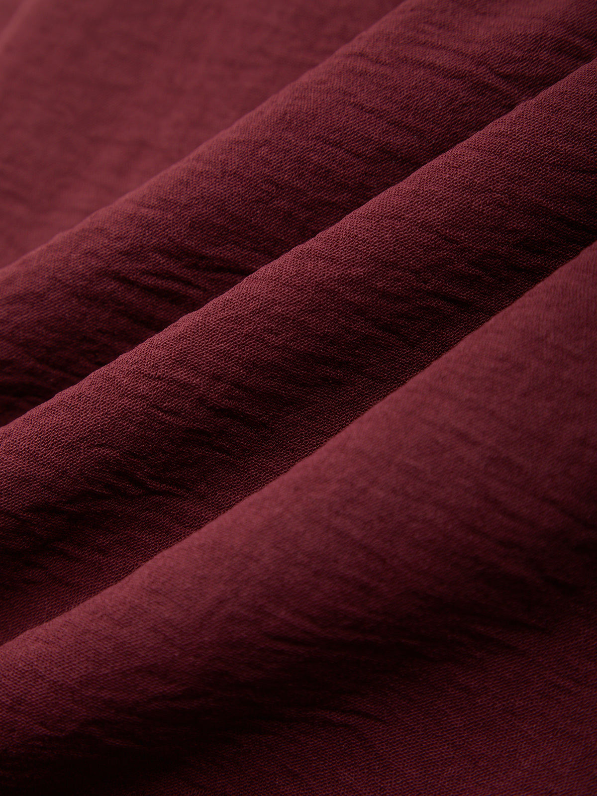 Close-up of maroon fabric with visible texture