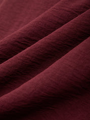 Close-up of maroon fabric with visible texture