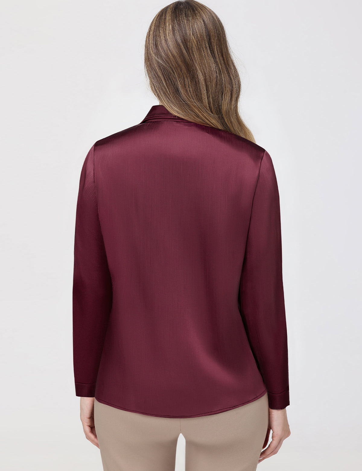 Maroon satin blouse worn by a person on a white background