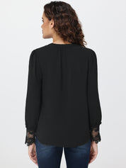 Woman wearing a black blouse with lace cuffs on a white background