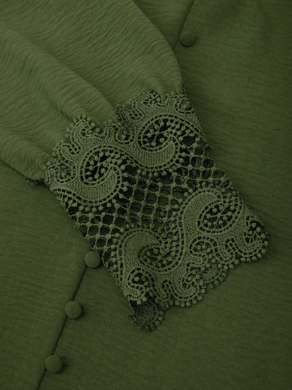 Green fabric with lace detailing and buttons