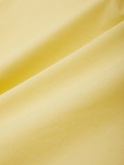 Close-up of smooth yellow fabric texture
