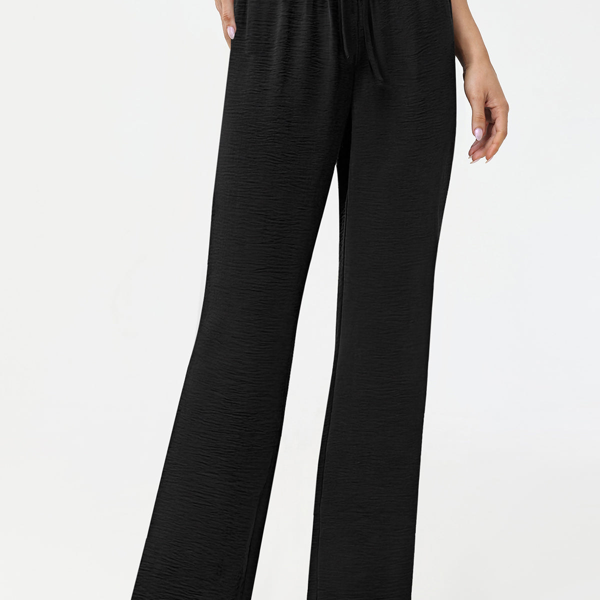Black wide-leg pants worn by a person on a white background