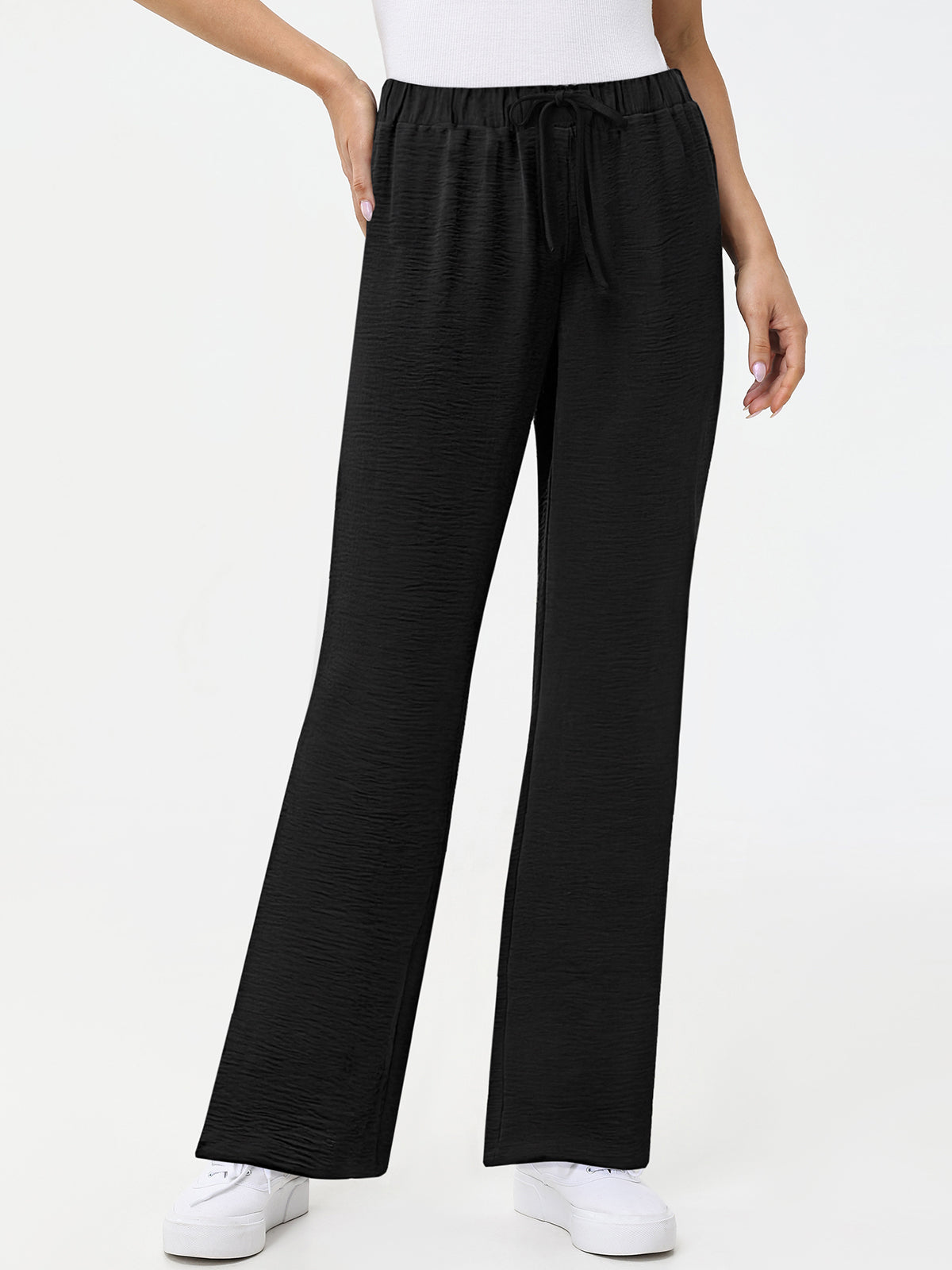 Black wide-leg pants worn by a person on a white background