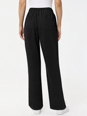 Black wide-leg pants worn by a person on a white background