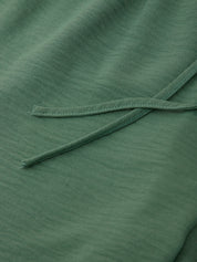 Close-up of green fabric with a visible seam