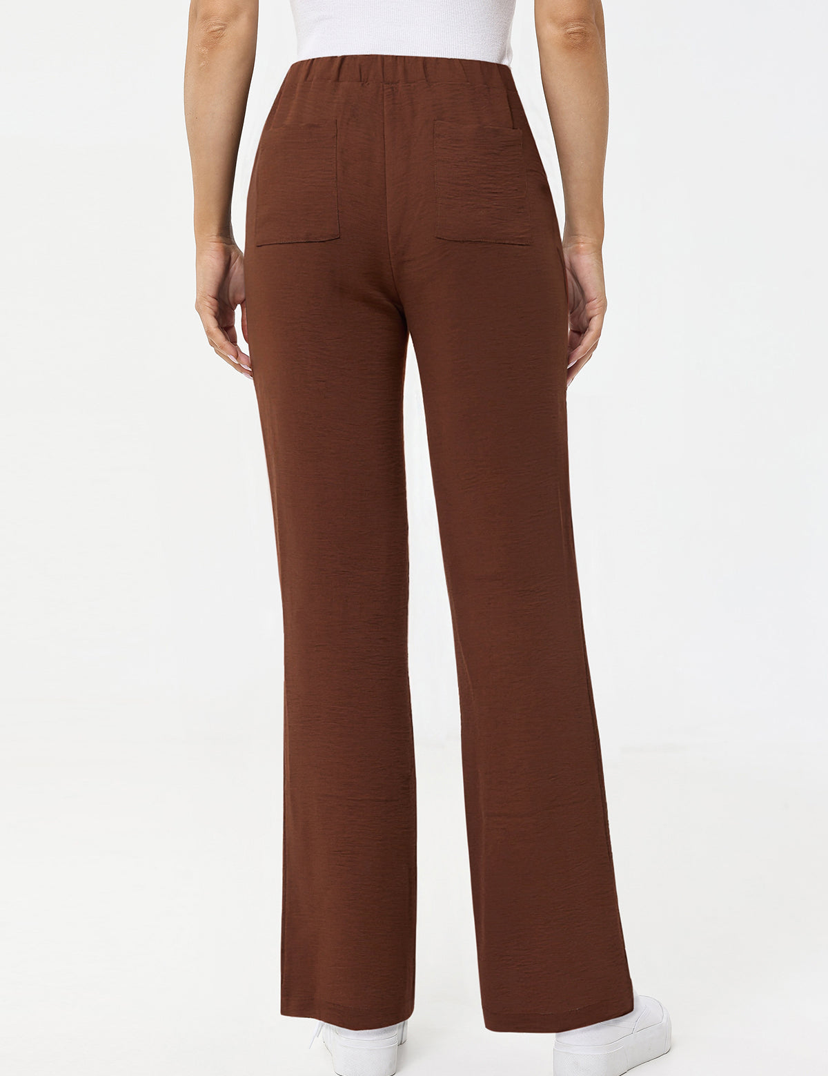 Brown pants worn by a person on a white background