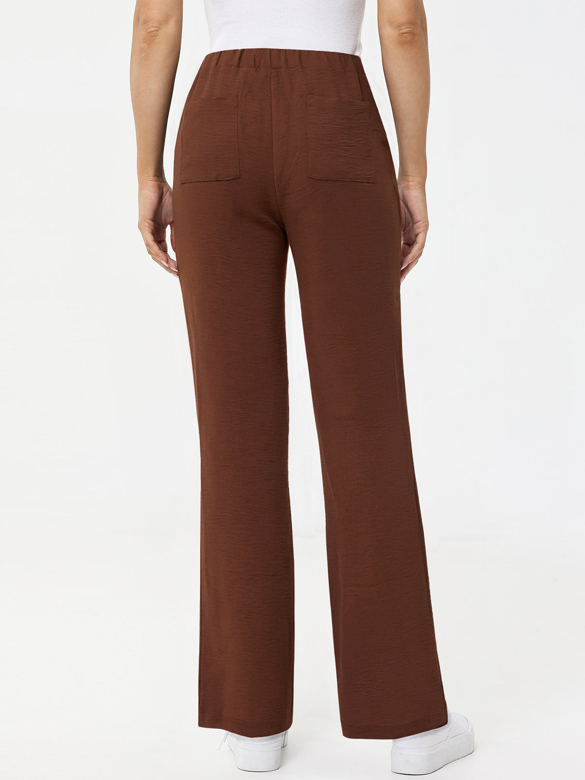 Brown pants worn by a person on a white background