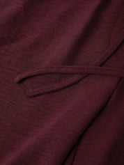 Close-up of a burgundy fabric with a tie detail