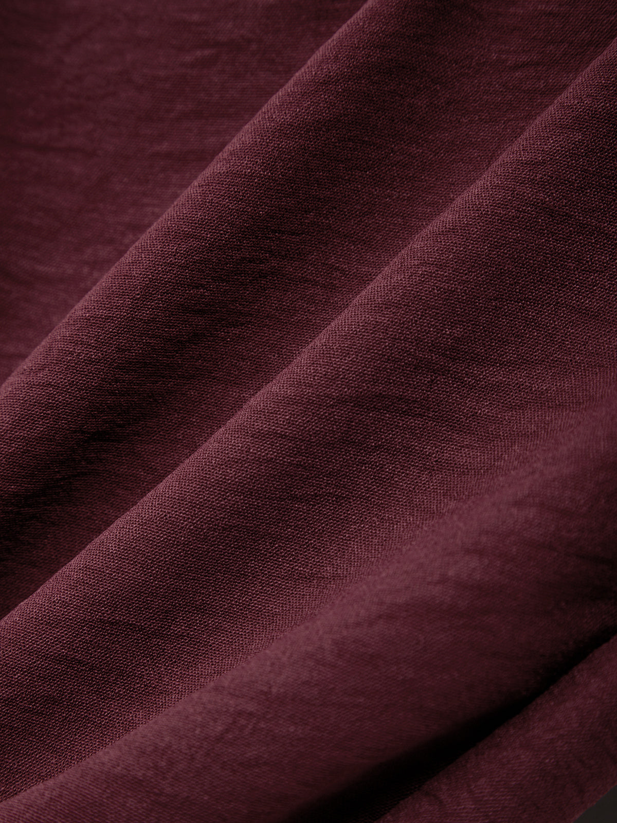 Close-up of dark purple fabric with a textured surface