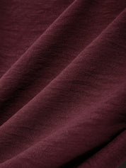 Close-up of dark purple fabric with a textured surface