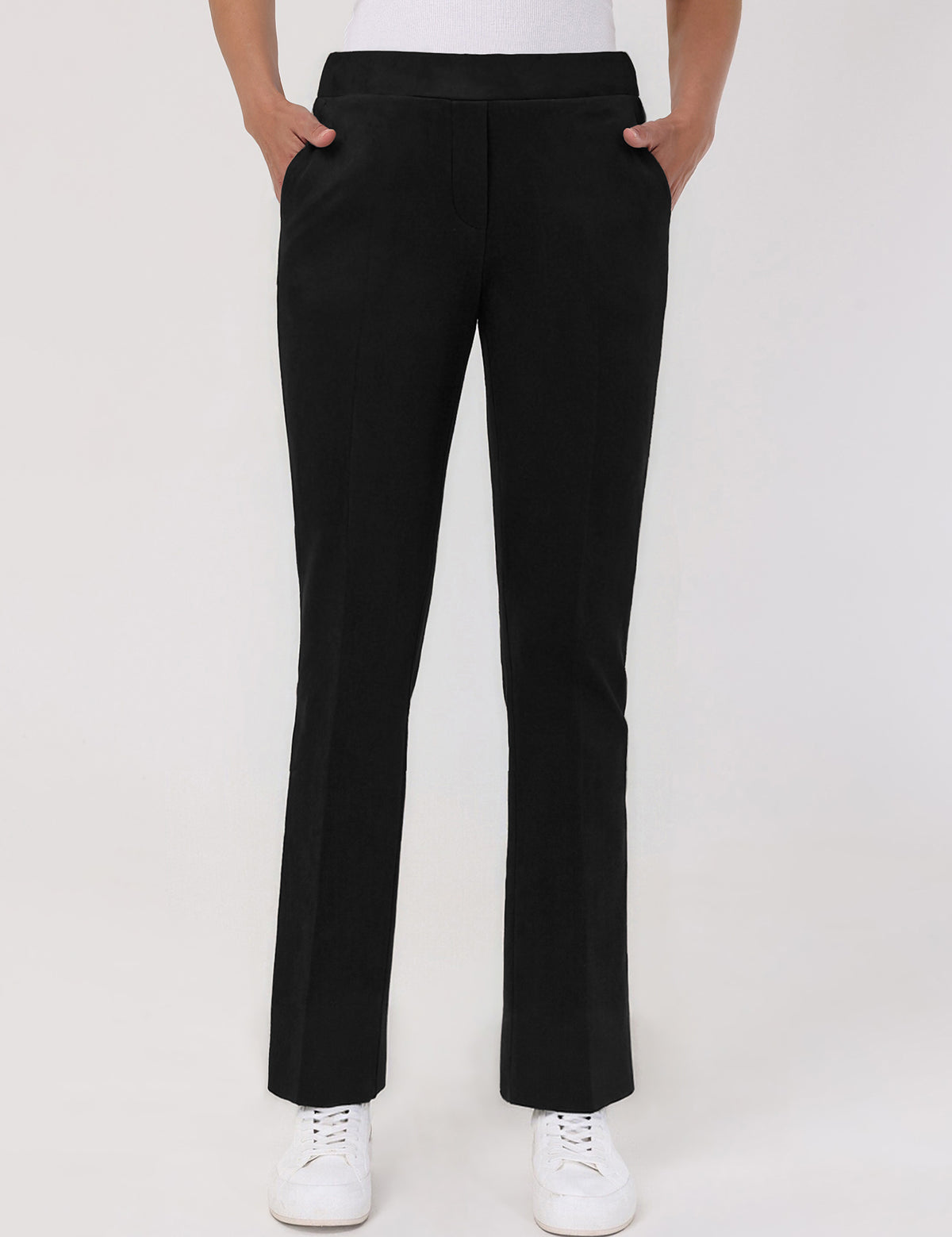 Black pants worn by a person on a white background