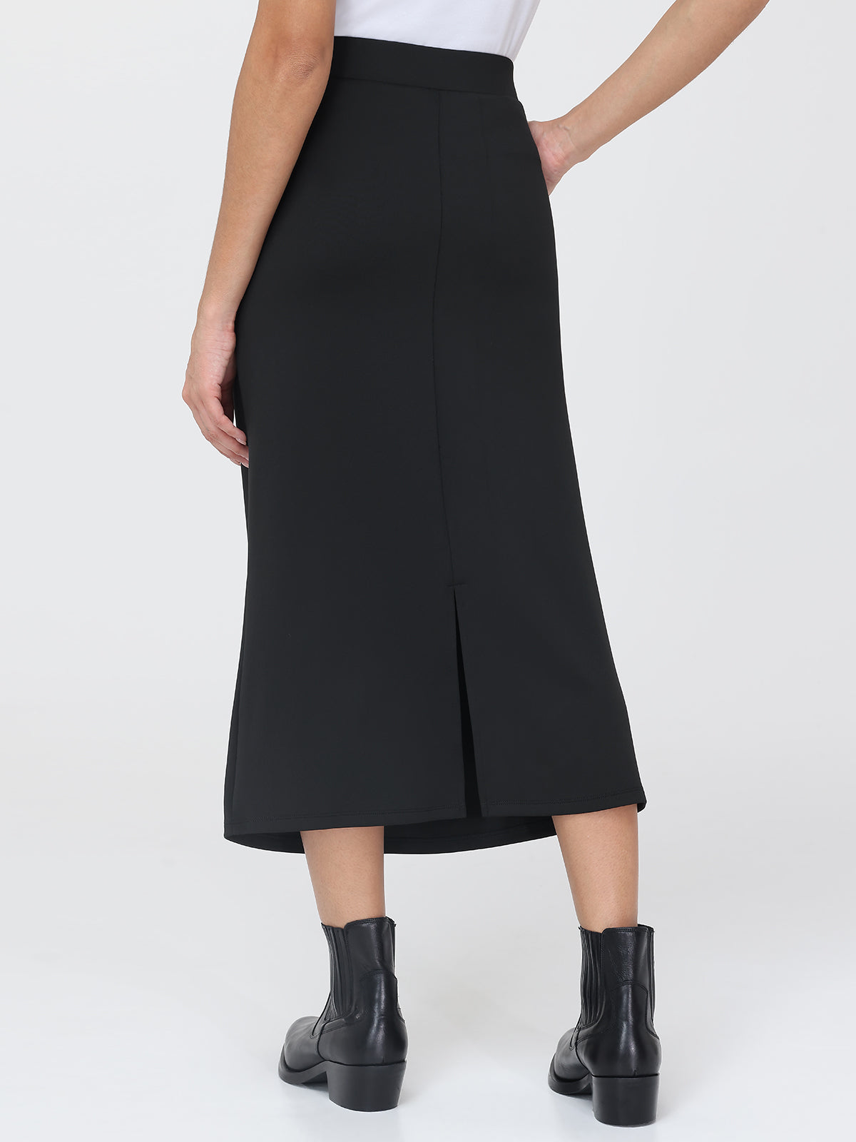 Black skirt worn by a person on a white background