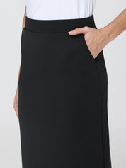Black skirt worn by a person on a white background